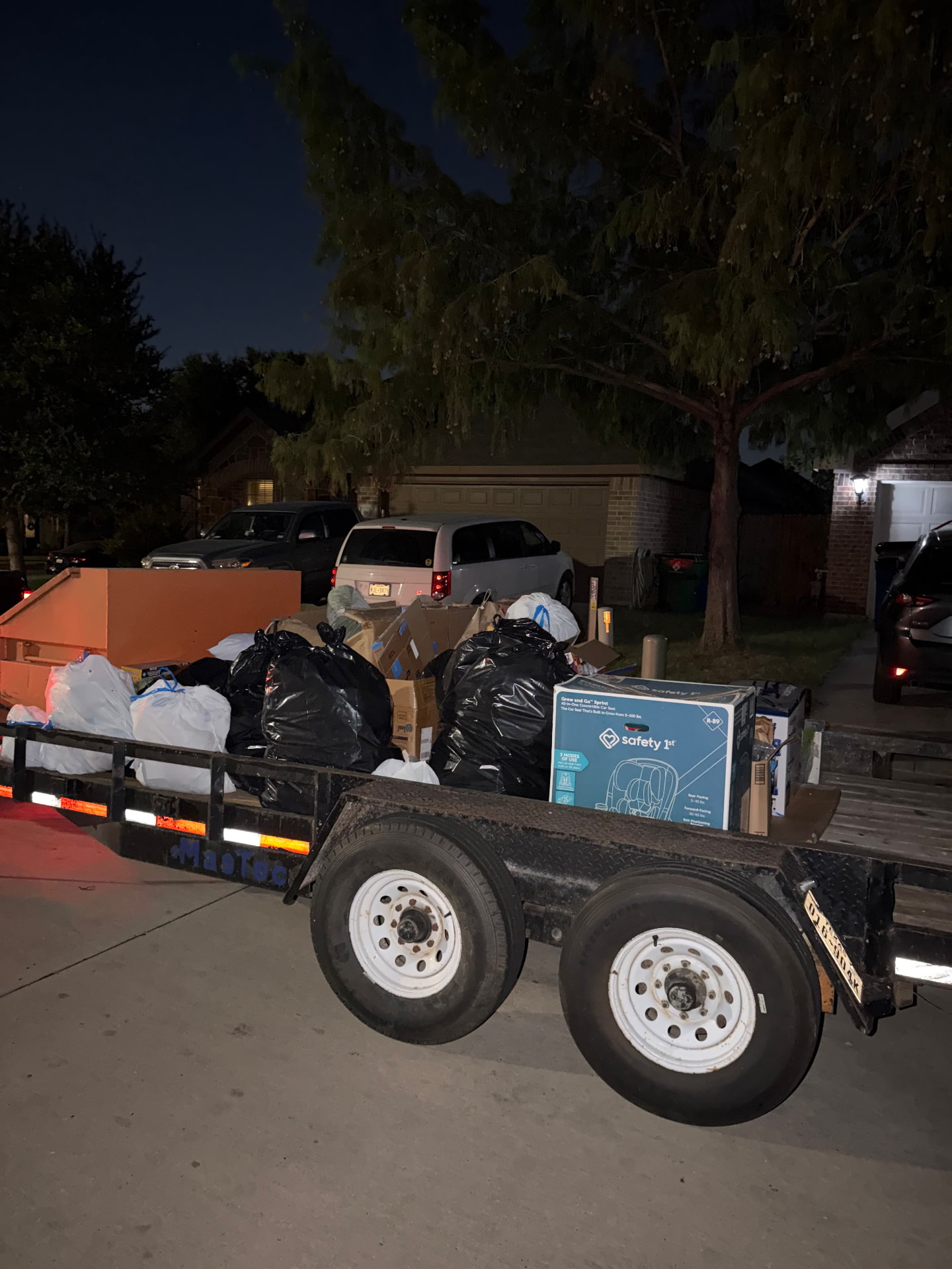 D&A Haul Away trailer loaded with bagged household junk and cardboard after a Burleson area pickup
